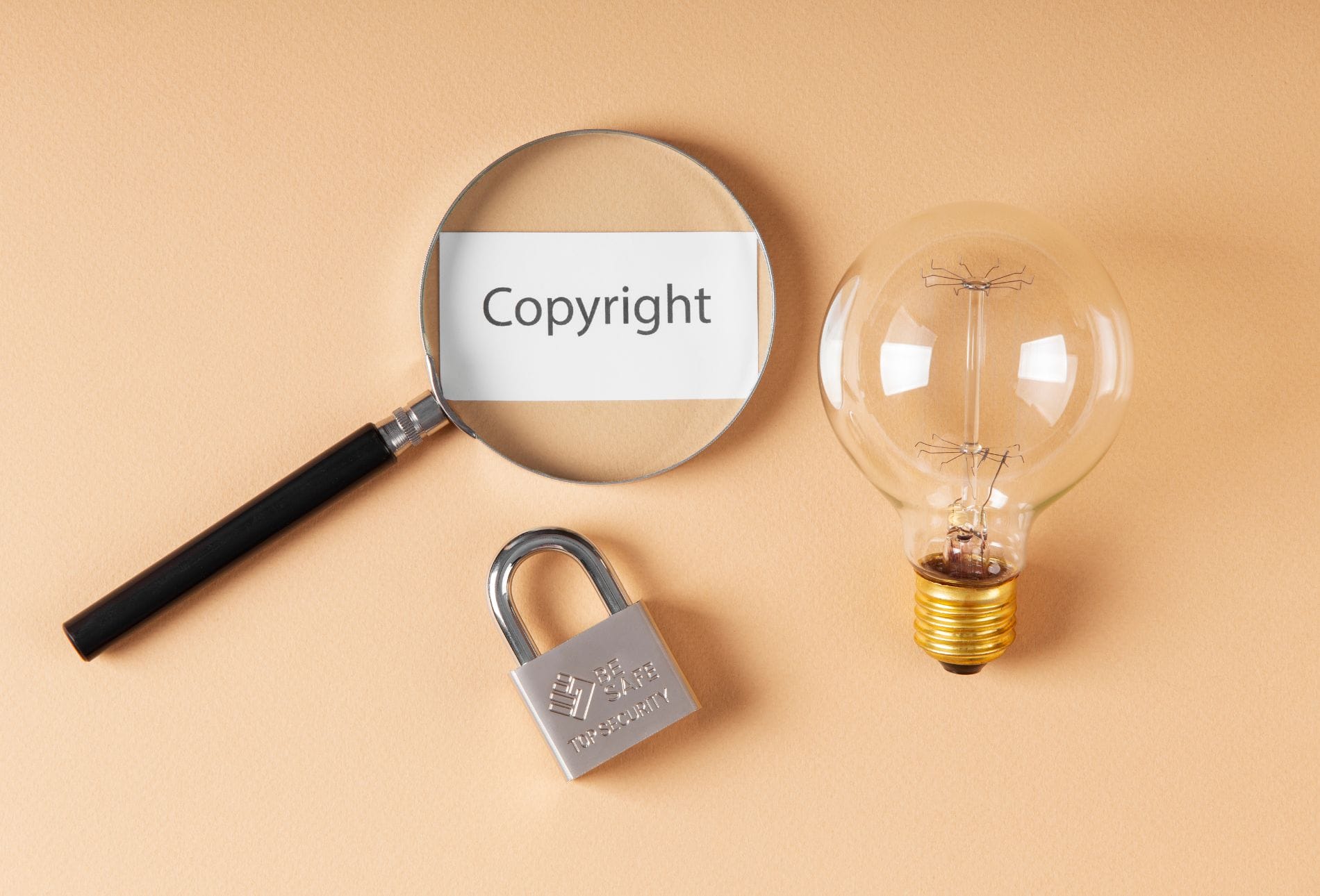 lightbulb, lock and magnifying glass over the word copyright, depicting intellectual property